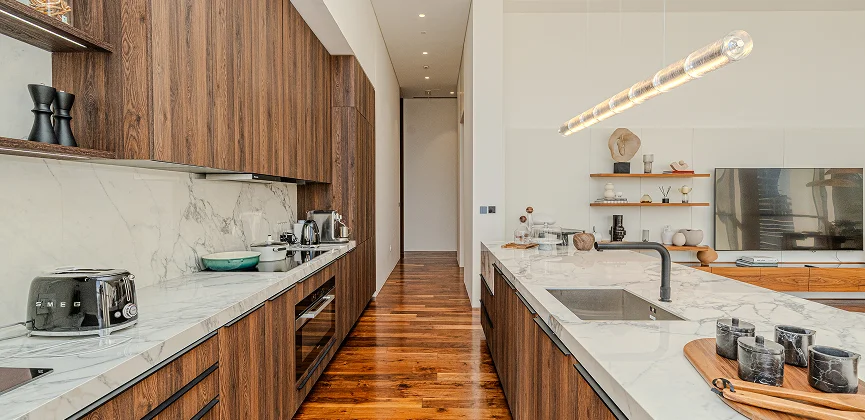 Residence 22 chef kitchen with marble surfaces and custom wood finish